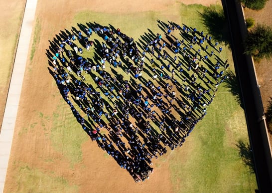 Kids in a Field Standing in a Heart Shape